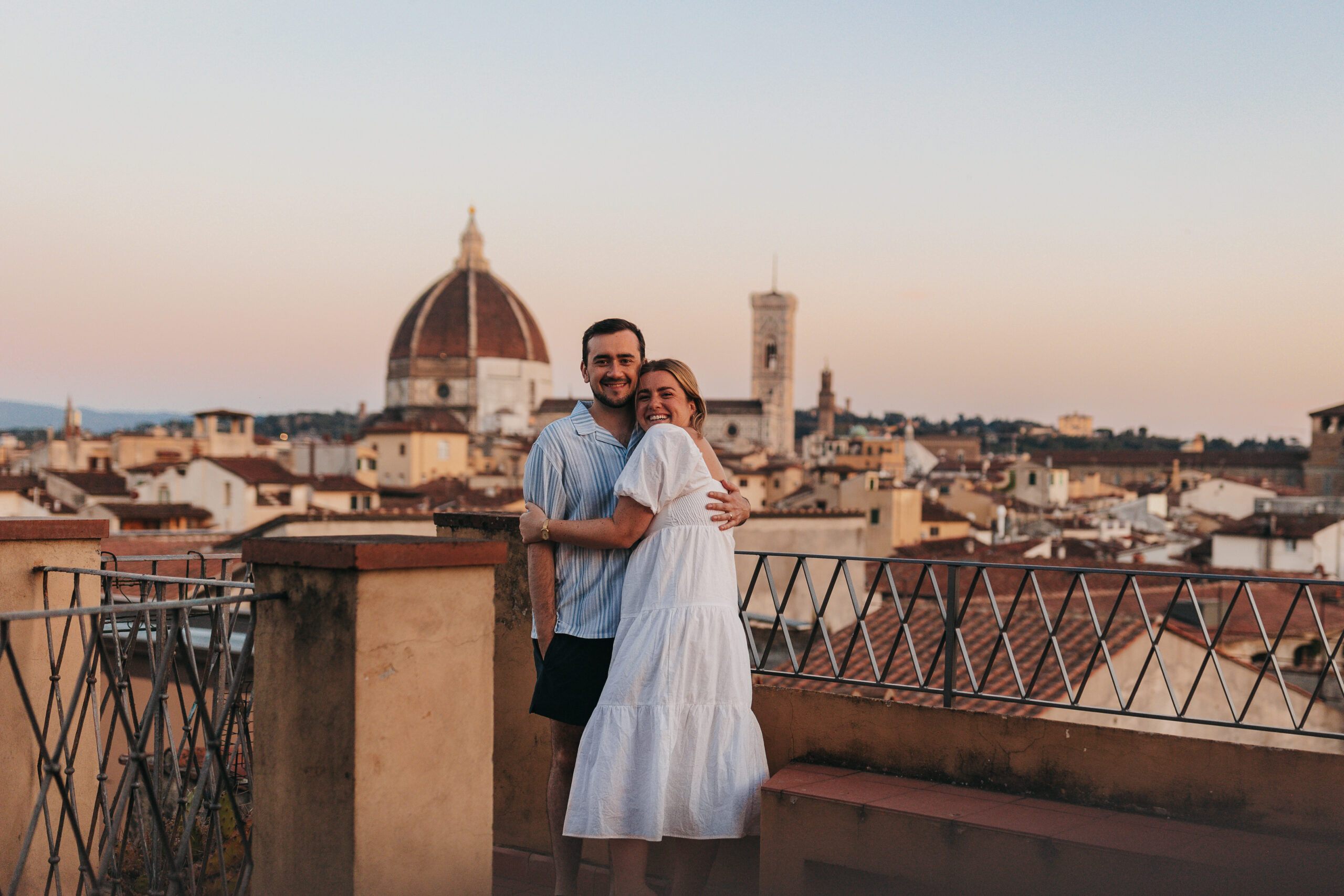 a couple hugging with the city of Florence in the background