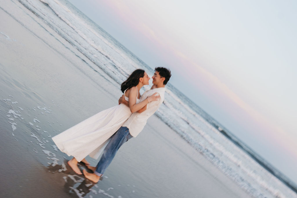 couple hugs on the beach at sunset